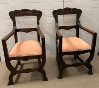 A pair of Victorian carved oak armchair in the 17th century Italian style curule style supports