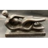 A reclining abstract bronze figure, signed Henry Moore