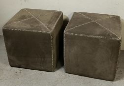 A pair of suede cube footstools with stiched detail