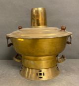 An antique brass oriental hotpot fondue soup warmer