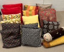 An assorted mix of cushions and bolster cushions, various styles