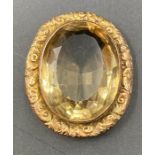 A 9ct gold mounted brooch with citrine style stone.