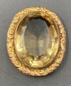 A 9ct gold mounted brooch with citrine style stone.