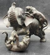 A Japanese bronze of an elephant and two tigers, signed to base.