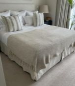 A Superking bed with natural linen headboard