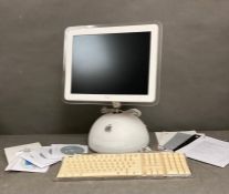 A 2002 Apple iMac 15inch complete with operating guide and programme disk