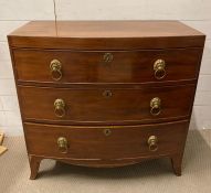A three drawer mahogany chest of drawers with lion drop handles with key (H87cm W90cm D48cm)