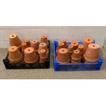 Two trays of terracotta flower pots, various sizes.