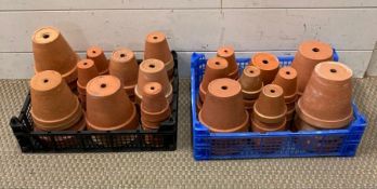 Two trays of terracotta flower pots, various sizes.