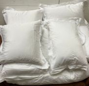 Three square, three rectangular pillows and Superking duvet all with white cotton bed linen.