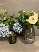 Two contemporary vases, one ribbed with faux flowers and a small OKA vase with faux flowers