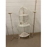 White wrought iron plant stand along with a pair of candlesticks