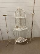 White wrought iron plant stand along with a pair of candlesticks