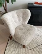 A Mid Century style chair with a sheepskin style covering