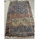 An Afghan rug with diamond geometric pattern to center 135cm x 230cm