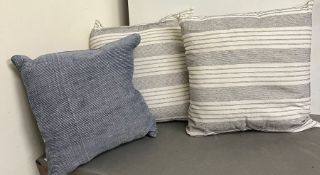 Two decorative striped cushions and one blue cushion