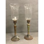 A pair of gothic style candlesticks with amphora glass shades