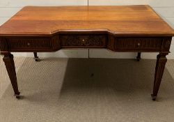 A writing desk with carved drawers and reeded tapering legs (78cm x 79cm x 150cm)