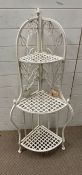 A white metal plant stand with three tiers