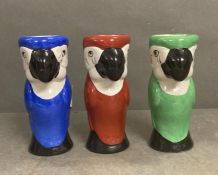 Three ceramic parrot themed vases one red, one blue and one green