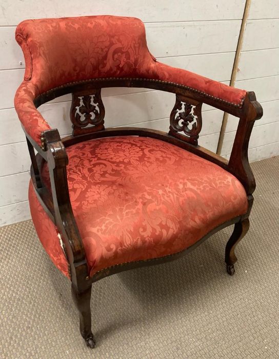 A Victorian style upholstered tub chair on castors