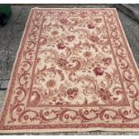 A Laura Ashley rug with cream grounds ad red scrolling foliage 240 cm x 165cm