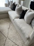 A large white sleek design ottoman style sofa