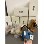 Five Steiff bears with red/white tags including Paddington Bear and one musical bear with yellow