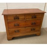 A two over two wooden chest of drawers (H82cm W110cm D46cm)