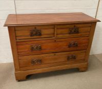 A two over two wooden chest of drawers (H82cm W110cm D46cm)