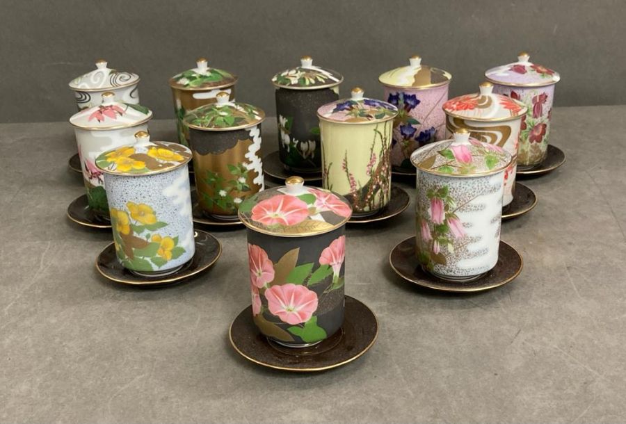 A selection of twelve floral decorated porcelain sake/tea cups and saucers
