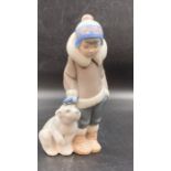 A Lladro figure of a child with a polar bear cub (5238)