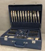 A Suissine twelve place setting canteen in a blue case.