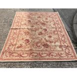 A Laura Ashley rug with cream grounds and red scrolling foliage 240cm x 165cm