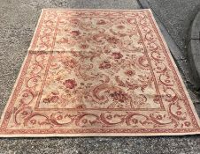 A Laura Ashley rug with cream grounds and red scrolling foliage 240cm x 165cm