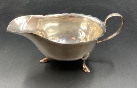 A silver sauce boat on three hoof feet, hallmarked for Sheffield 1967 by Mappin & Webb (