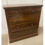 An oak two over three chest of drawers with drop down handles (H104cm W100cm D46cm)