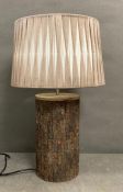A rustic wooden tree trunk effect table lamp