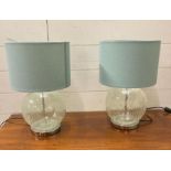 A pair of cracked glass table lamps with turquoise shades
