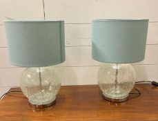 A pair of cracked glass table lamps with turquoise shades