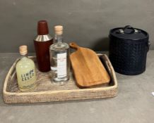 A rattan bar tray with cocktail shaker, leather ice bucket, a bottle of Daylesford Gin, A bottle
