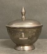 A white metal candle holder marked "Highgrove"
