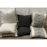 Three striped cushions, two blue cushions and two patterned cushions