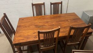 A hardwood dining table with eight chairs