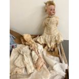 A Vintage doll with original clothes, china face and stamped Paris S F B J BEBES