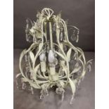 A palm shaped leaves chandelier with glass droplets