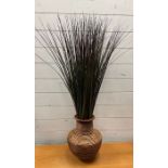 Faux grass in an urn pot