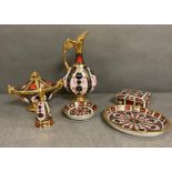 A selection if Royal Crown Derby to include pin dishes, a candle snuffer and a swan neck ewer.