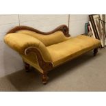 A Victorian style carved chaise longue on turned feet