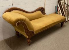 A Victorian style carved chaise longue on turned feet